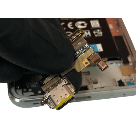 a person holds a lg charging port to suggest replacement