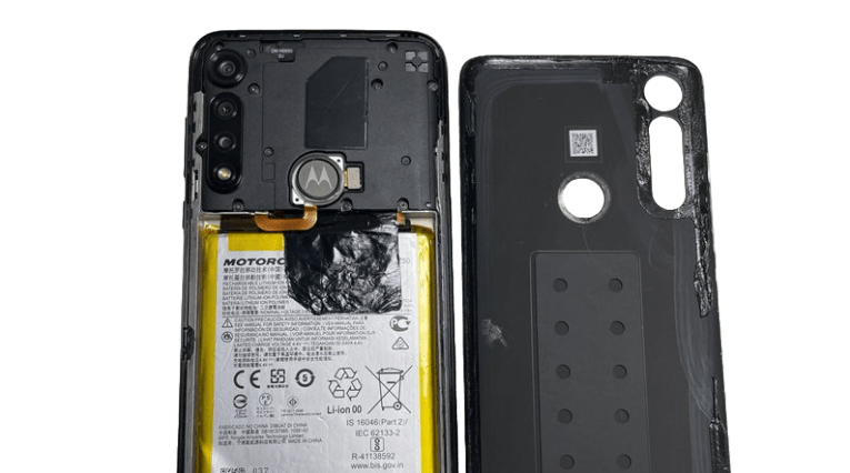 A motorola phone's rear view displaying the battery and its cover, emphasizing the phone's design and battery